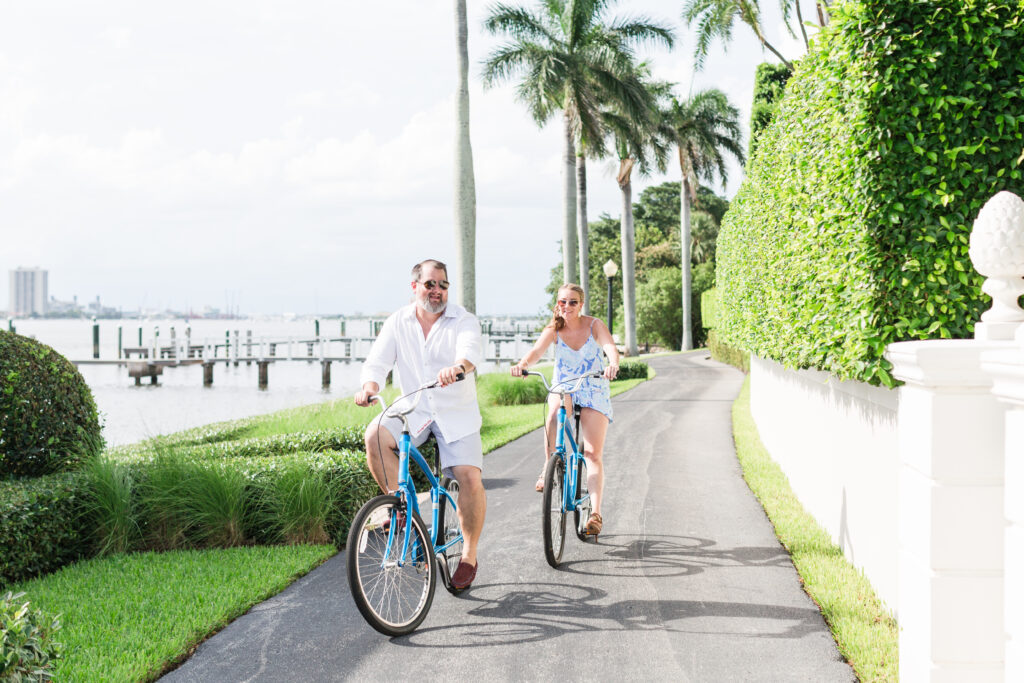 Amy and Ali riding bikes on the bike trail in Palm Beach. Engagement Photos